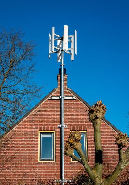 Besides gigantic structures that populate the world’s largest wind farms, there are also small-scale micro-turbines for residential houses. (Source: Wirestock  - stock.adobe.com)