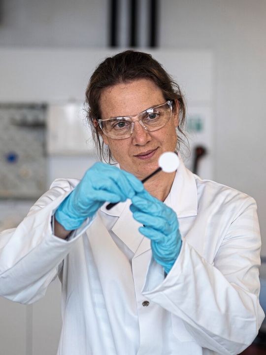 Empa-Forscherin Meike Heinz hält ein Scheibchen des Keramikelektrolyten für die Salzbatterie.(Bild:  Empa)