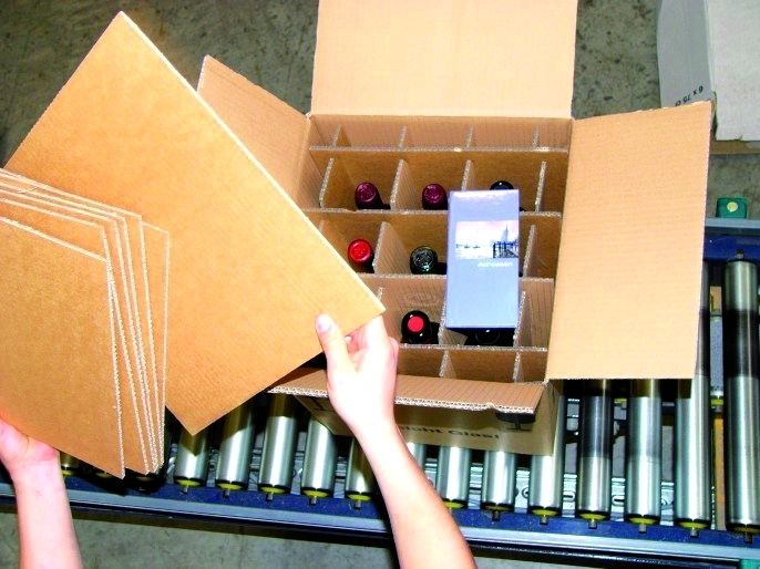 Das Flaschensortiment, wie hier neun Weinsorten aus aller Welt, und die beigepackte Broschüre wird zum Schluss mit einem Karton als Sicherheitsschutz abgedeckt. (Archiv: Vogel Business Media)