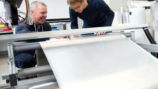 Schluss mit „anhänglichen“ Kunststofffolien und Explosionsgefahr: Jürgen Gröninger (l.) und Sascha Wagner, Ingenieure am Laserzentrum der FH Münster messen die Größe der Perforationslöcher in einer Verpackungsfolie. Die Forscher haben zusammen mit dem Verpackungsmittelhersteller Empac ein Verfahren entwickelt, das die Folie antistatisch werden lässt.  (FH Münster / Pressestelle)