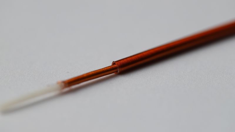 Each fiber is wrapped in tightly insulated copper wire electrodes that are only slightly thicker than a human hair. When a voltage is applied to these electrodes, electrostatic forces repeatedly align the fibers with one another. As a result, the inner fiber slides inside the outer one—much like a telescope. (Source: EPFL)