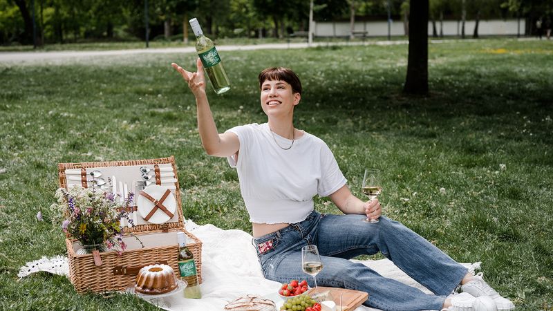Frau beim Picknick mit Wein aus PET-Flasche (Symbolbild)(Bild:  Alpla)