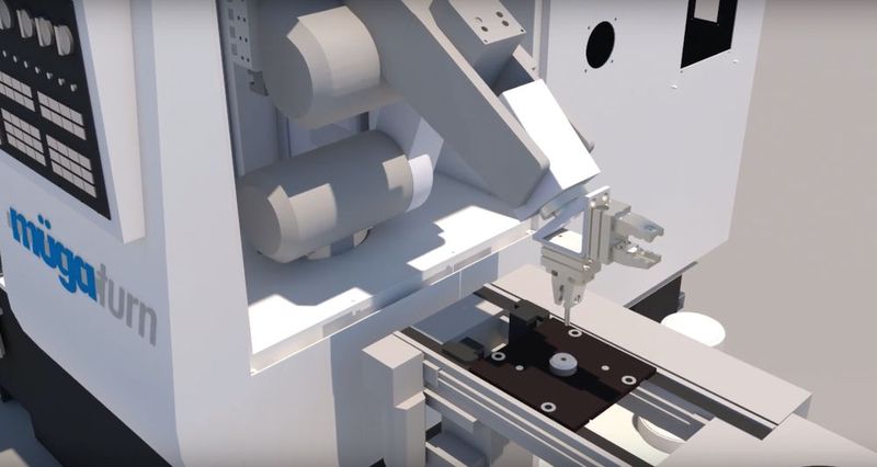 Ein Roboter am Portal des Bearbeitungszentrums entnimmt den Rohling vom Werkzeugträger und setzt ihn in das Spannfutter ein bzw. wendet ihn für beidseitige Bearbeitung. (Bild: Feintechnikschule Schwenningen)