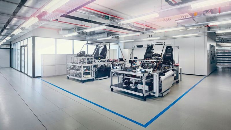 Das sogenannte Testhaus ist gar kein Haus, sondern eine Etage im Elektronik-Integrationszentrum. Dennoch hat dieser Begriff seine Berechtigung: Unter einem Dach prüfen hier Spezialisten jede Elektronik, vom Fensterheber bis zum Fahrerassistenzsystem, auf einwandfreie Funktion. Um das in einer frühen Phase zu ermöglichen, lange bevor der erste Prototyp auf die Straße entlassen wird, nutzen die Entwickler Hardware-in-the-Loop-Prüfstände. Das Steuergerät und andere Komponenten, etwa Scheinwerfer oder Lenkrad, werden an einen leistungsfähigen Rechner in Schrankgröße angeschlossen. Der gaukelt dem Steuergerät eine reale Fahrt vor, Gefahrensituationen und Fahrerreaktion inklusive.  (Dr. Ing. h.c. F. Porsche AG)