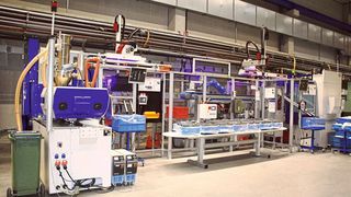 Blick ins Geschehen bei Happ Kunststoffspritzgusswerk und Formenbau, und auf die Spritzgießmaschinen der Type Ecopower 110/350 von Wittmann Battenfeld. Das Besondere ist, dass man zwei dieser Anlagen mit staufähigen Fördersystemen verbunden hat. So sichert man auch bei komplexen Baugruppen die Qualität. (Wittmann Battenfeld)