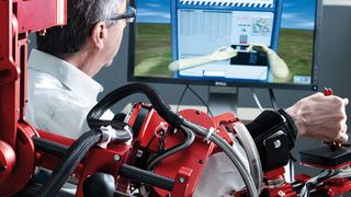 Nach einem Schlaganfall müssen alltägliche Bewegungen neu eintrainiert werden: Therapieroboter ARMin unterstützt den behinderten Arm des Patienten bei der Aufgabe, die der Bildschirm als virtuelle Realität vorgibt. (Roland Tännler / ETH Zürich)