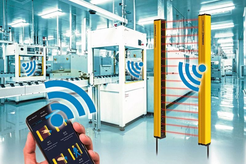 YBES Sicherheitslichtvorhänge von Contrinex verfügen über eine Bluetooth BLE-Schnittstelle zur Konfiguration und Überwachung per Smartphone oder Tablet. (Contrinex, Shutterstock/ssguy/Hand Robot)