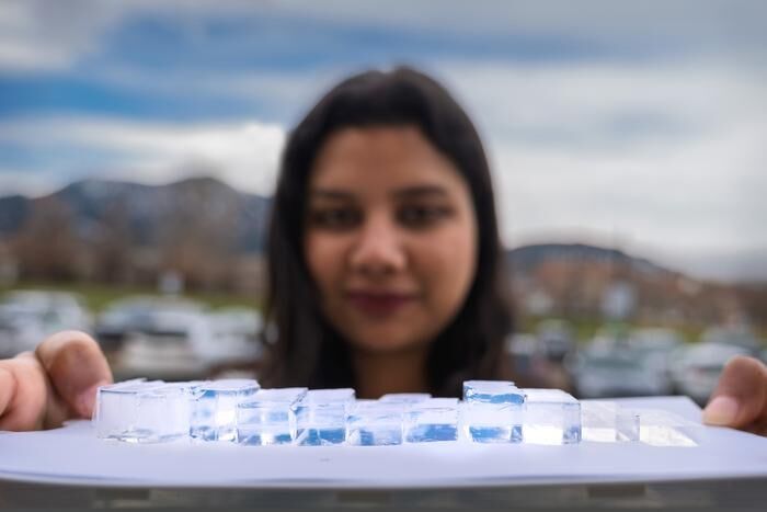 Shakshi Bhardwaj holds up blocks in different sizes of a new material nearly transparent insulation material called Mochi, which was designed buy CU Boulder researchers in physics professor Ivan Smalyukh’s lab. (Source: Glenn J. Asakawa/CU Boulder)
