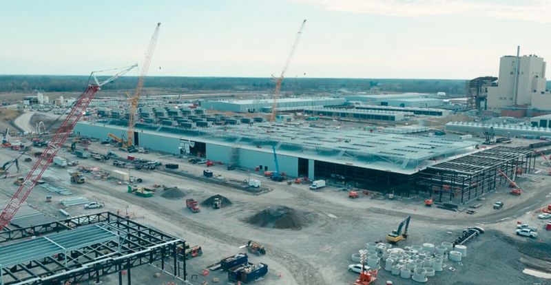 Die großen Hallen auf dem Gelände „CB-3“, „CB-4“ sollen im Juli und August ans Netz gehen. Auf diesem Bld noch nicht erkennbar sind zwei große Tanks, die das Glykol-Wasser-Gemisch enthalten, mit dem die IT in den großen Hallen im Direct-to-Chip-Cololing-Verfahren gekühlt werden sollen. Sind die CDUs und die Server einmal mit der Flüssigkeit gefüllt, ist der Kühlkreislauf geschlossen. Auch fehen bei dem Bild noch die großen Power-Module, die Schneider Electric liefert, und die jeweils an einer Längsseite aufgestellt werden.  (Bild: Schneider Electric)