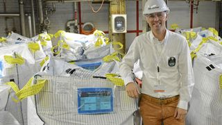 Natron Energy CEO Colin Wessells stands next to battery-grade Prussian blue at Arxada's facility in Visp, Switzerland. (Source: Business Wire)