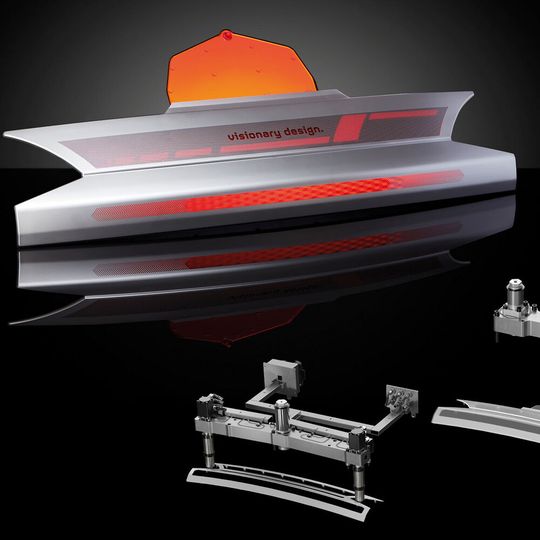 A smart automotive rear panel in 2K technology, consisting of a PC/ABS frame overmolded with PMMA or PC, is injection molded in the first phase using a hydraulic 2-drops system from Oerlikon HRS Flow and then overmolded using a single nozzle from the Ga series. A smart automotive rear panel in 2K technology, consisting of a PC/ABS frame overmolded with PMMA or PC, is injection molded in the first phase using a hydraulic 2-drops system from Oerlikon HRS Flow and then overmolded using a single nozzle from the Ga series.