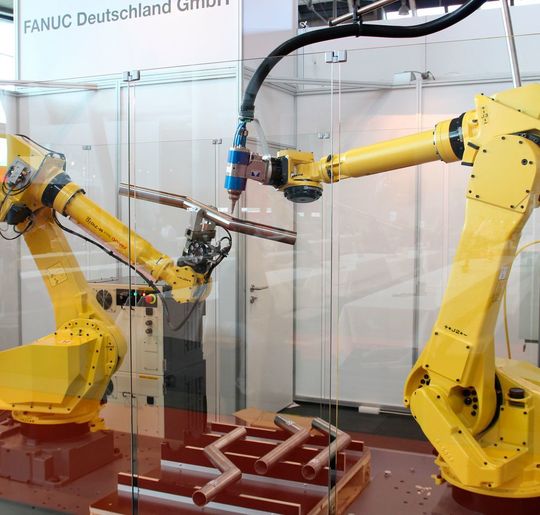 Premiere für Fanuc Deutschland auf der LASYS 2016: Zwei Roboter demonstrieren die effektive Kollaboration zwischen Scanner-Greifer- und Bearbeitungsroboter, der mit dem Fanuc-Faserlaser YLR mit 3 kW Leistung zur 3D-Rohrbearbeitung ausgestattet ist. Premiere für Fanuc Deutschland auf der LASYS 2016: Zwei Roboter demonstrieren die effektive Kollaboration zwischen Scanner-Greifer- und Bearbeitungsroboter, der mit dem Fanuc-Faserlaser YLR mit 3 kW Leistung zur 3D-Rohrbearbeitung ausgestattet ist.