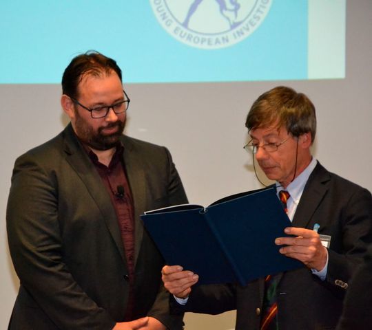 Prof. Reinhard Jahn (r.), Direktor des Max-Planck-Instituts für biophysikalische Chemie und Jury-Vorsitzender überreicht Prof. Adrian Liston die Award-Urkunde. Prof. Reinhard Jahn (r.), Direktor des Max-Planck-Instituts für biophysikalische Chemie und Jury-Vorsitzender überreicht Prof. Adrian Liston die Award-Urkunde.