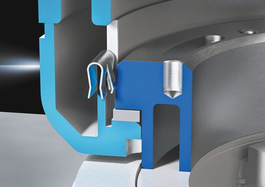 So wird der automatische Potenzialausgleich erzeugt: An den Tragarmgelenken bewirkt eine Feder eine permanente Schleifwirkung zwischen zwei drehbaren und ineinander gesteckten Bauteilen.