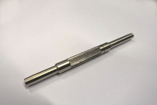 Eine Welle, die an dem entsprechenden Abschnitt geriffelt wurde. Eine Welle, die an dem entsprechenden Abschnitt geriffelt wurde.