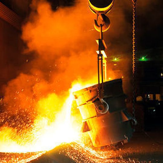 Liquid silicon metal flows out of ladles onto a bed of silicon sand, where it can cool and solidify. Liquid silicon metal flows out of ladles onto a bed of silicon sand, where it can cool and solidify.