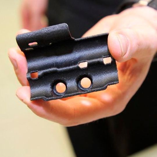 A hydraulic line bracket for the McLaren MCL32 race car, 3D-printed on a Stratasys FDM 3D printer using Nylon12CF material. A hydraulic line bracket for the McLaren MCL32 race car, 3D-printed on a Stratasys FDM 3D printer using Nylon12CF material.
