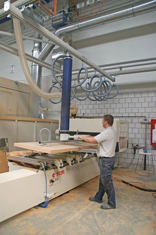 Mit dem manuell fahrbaren Schmalz Vacuhandling JumboErgo 110 erfolgt der Transport der Türen zur CNC-Fräse und nach Bearbeitung zur nächsten Station. Mit dem manuell fahrbaren Schmalz Vacuhandling JumboErgo 110 erfolgt der Transport der Türen zur CNC-Fräse und nach Bearbeitung zur nächsten Station.