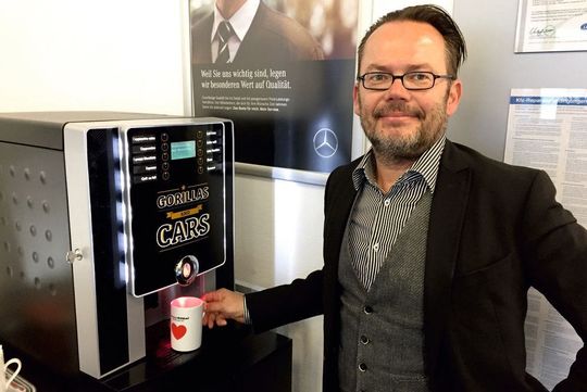 Stefan Göbel am von ihm vertriebenen Kaffeeautomaten.