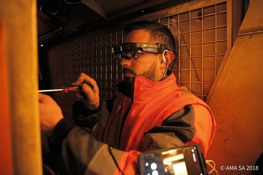 Monteur und Experte befinden sich in getrennten Räumen, teilen sich jedoch durch die Datenbrille das gleiche Sichtfeld. Auf diese Weise kann der Experte den Monteur bei seiner Tätigkeit auch aus der Entfernung unterstützen.