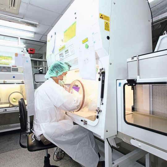 Women working in containment surrounding Women working in containment surrounding