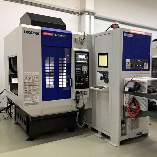 The automated production cell comprising Brother Speedio M140X1 5-axis mill-turn centre equipped with a Feedio automation system has arrived in the Whitehouse Machine Tools showroom in Kenilworth, ready for shipment to Southern Manufacturing 2019. The automated production cell comprising Brother Speedio M140X1 5-axis mill-turn centre equipped with a Feedio automation system has arrived in the Whitehouse Machine Tools showroom in Kenilworth, ready for shipment to Southern Manufacturing 2019.
