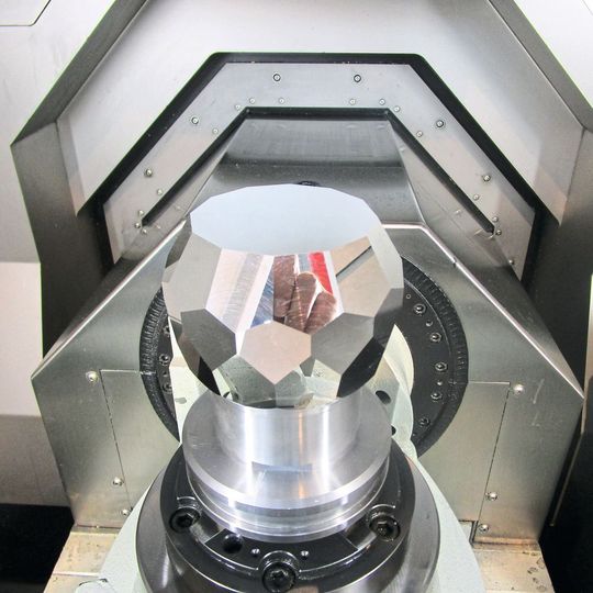 Polyhedron with reflective surfaces milled from a single aluminum block. Polyhedron with reflective surfaces milled from a single aluminum block.