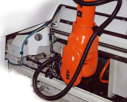 Der Roboter greift mit einem Vakuum-Sauger in den Arbeitsbereich der Zugzange der Kreissäge, um einen scheibenförmigen Sägeabschnitt aus der Maschine zu entnehmen. Bilder: Kasto Der Roboter greift mit einem Vakuum-Sauger in den Arbeitsbereich der Zugzange der Kreissäge, um einen scheibenförmigen Sägeabschnitt aus der Maschine zu entnehmen. Bilder: Kasto