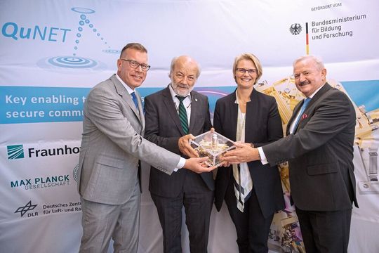 Prof. Dr. Andreas Tünnermann, Institutsleiter am Fraunhofer IOF, Prof. Dr. Gerd Leuchs, Direktor am Max-Planck-Institut für die Physik des Lichts, Bundesministerin Anja Karliczek und Fraunhofer-Präsident Prof. Dr. Reimund Neugebauer mit einer verschränkten Photonenpaarquelle für den Einsatz im Weltraum (v.l.n.r). Prof. Dr. Andreas Tünnermann, Institutsleiter am Fraunhofer IOF, Prof. Dr. Gerd Leuchs, Direktor am Max-Planck-Institut für die Physik des Lichts, Bundesministerin Anja Karliczek und Fraunhofer-Präsident Prof. Dr. Reimund Neugebauer mit einer verschränkten Photonenpaarquelle für den Einsatz im Weltraum (v.l.n.r).