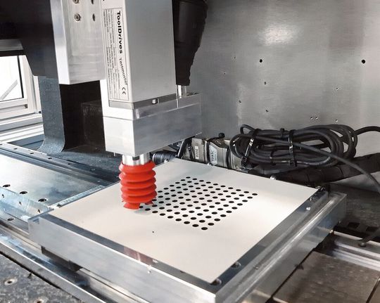 Bild 1: In nur 17 Sekunden schafft es die High Speed Drilling Unit 100 Löcher mit einem Durchmesser von 6 mm und 6 mm Tiefe präzise in eine beschichtete Verbundholzplatte zu bohren. Bild 1: In nur 17 Sekunden schafft es die High Speed Drilling Unit 100 Löcher mit einem Durchmesser von 6 mm und 6 mm Tiefe präzise in eine beschichtete Verbundholzplatte zu bohren.