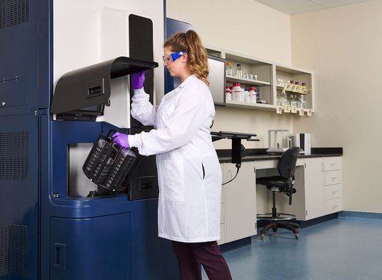 A quality control specialist loads multiple sample cartridges into the Rapid Micro Biosystems Growth Direct instrument for automated, high-throughput microbial contaminant testing. A quality control specialist loads multiple sample cartridges into the Rapid Micro Biosystems Growth Direct instrument for automated, high-throughput microbial contaminant testing.