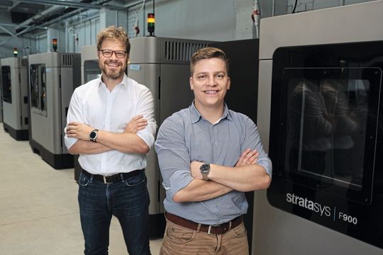 AM Craft Co-founders Jānis Jātnieks (right) and Didzis Dejus in front of the Stratasys F900 3D Printers. AM Craft Co-founders Jānis Jātnieks (right) and Didzis Dejus in front of the Stratasys F900 3D Printers.