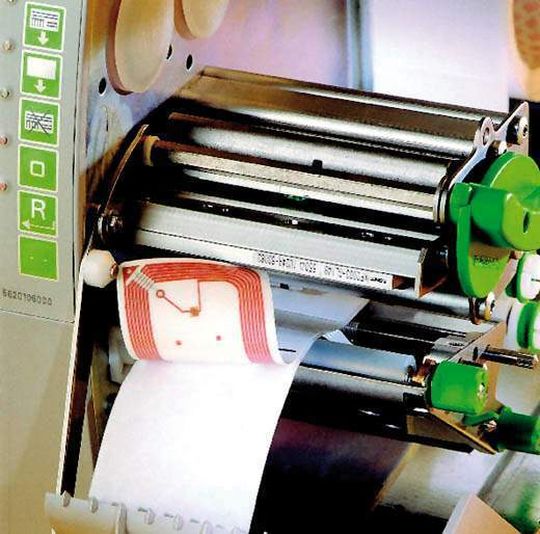 Platzsparend ist der Transponder an der Rückseite des Smart Labels angebracht. Er bezieht seine Energie aus einem Aktivierungssignal des Schreib-Lese-Gerätes parallel zum Druck der Etiketten. Platzsparend ist der Transponder an der Rückseite des Smart Labels angebracht. Er bezieht seine Energie aus einem Aktivierungssignal des Schreib-Lese-Gerätes parallel zum Druck der Etiketten.