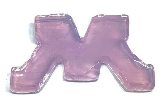 This block M is composed of engineered bacteria and silica — a material commonly used in plaster — cross-linking together. The purple tint is a protein produced by the bacteria. If the M was damaged, researchers could add nutrients and any cracks would self-heal. This block M is composed of engineered bacteria and silica — a material commonly used in plaster — cross-linking together. The purple tint is a protein produced by the bacteria. If the M was damaged, researchers could add nutrients and any cracks would self-heal.