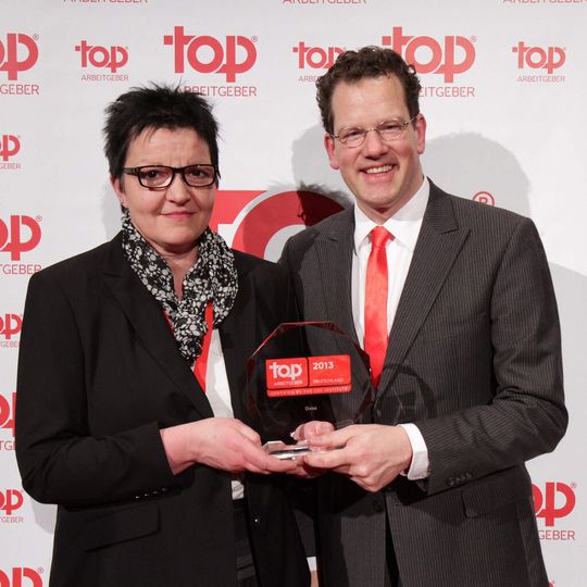 Iris Holk, Leiterin des operativen Bereiches innerhalb von Human Resources bei Oxea, und David Plink, CEO beim Researchunternehmen CRF Institute bei der Übergabe der Auszeichnung.