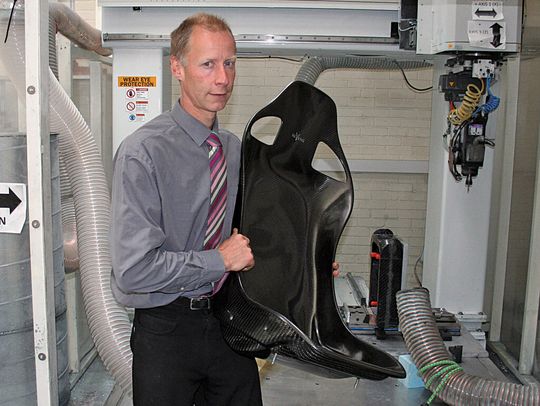 Reverie MD Simon Farren with a completed racing seat. His company relies on CAD/CAM software to make moulds for the CFR components. Reverie MD Simon Farren with a completed racing seat. His company relies on CAD/CAM software to make moulds for the CFR components.