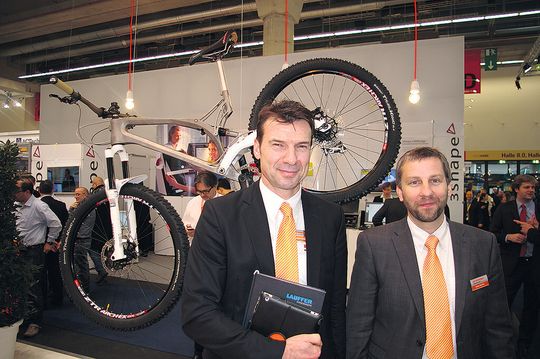 Renishaw's Albert Rundel (l.), product manager, and Robin Weston, marketing manager of the additive manufacturing products division, in front of the titanium frame the company developed with Empire Cycles. Renishaw's Albert Rundel (l.), product manager, and Robin Weston, marketing manager of the additive manufacturing products division, in front of the titanium frame the company developed with Empire Cycles.