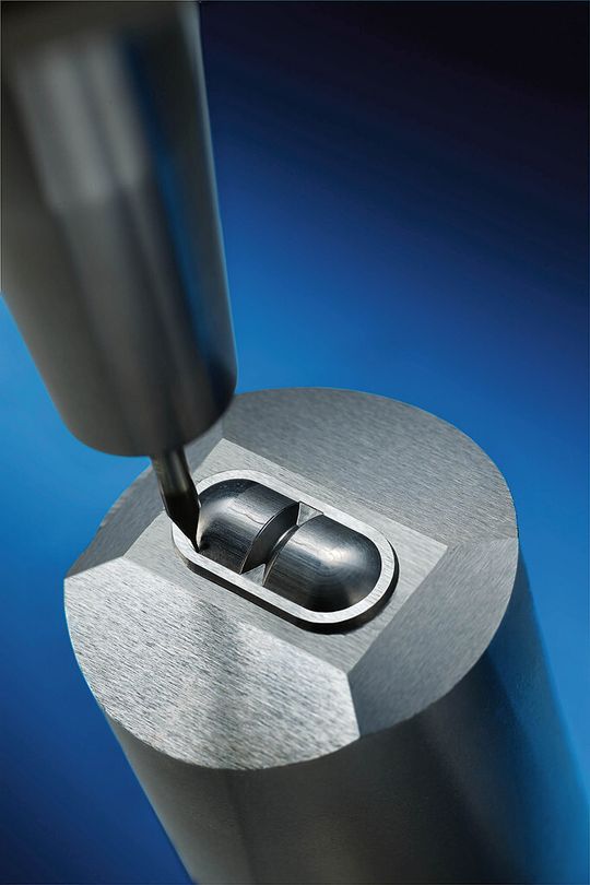 Micro-milling cutter machines a hardened extrusion die. Micro-milling cutter machines a hardened extrusion die.