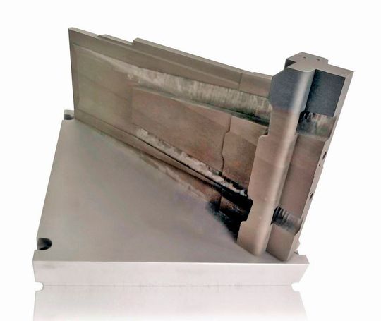 The additively manufactured tooling insert on its build platform. The additively manufactured tooling insert on its build platform.