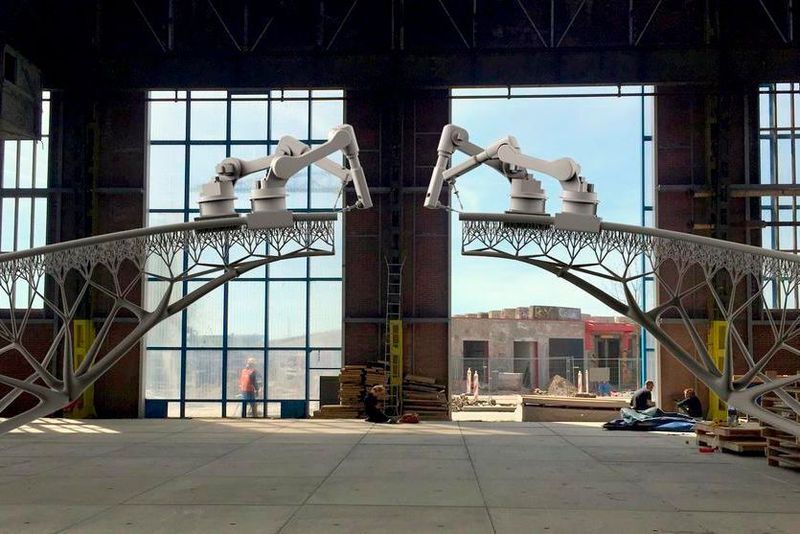 Simulation eines Brückenbaus per Roboter: Die Roboter fahren auf den von ihnen selbst gefertigten Stahlelementen. Der 1500 °C heiße Stahl wird praktisch in die Luft gespritzt und erstarrt.