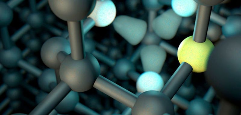 Im nahezu perfekten Gitter gibt es Stellen an denen ein Kohlenstoffatom zwischen den benachbarten Atomen (weiß) fehlt und daneben ein Stickstoffatom (gelb) eingebaut ist.