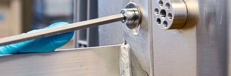 A traditional welding seam – as seen in the foreground – is not produced when joining the aluminium flange and the aluminium wall as seen in the background.