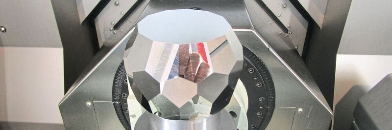Polyhedron with reflective surfaces milled from a single aluminum block.
