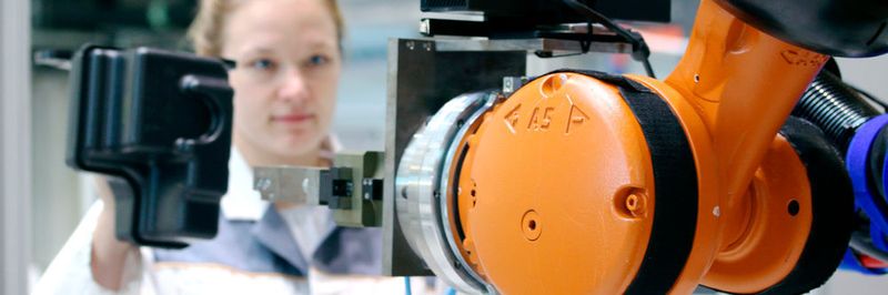 Der Roboter erkennt das Bauteil, das die Mitarbeiterin hält und folgt behutsam ihrer Hand bis zur Übergabe des Werkstücks.