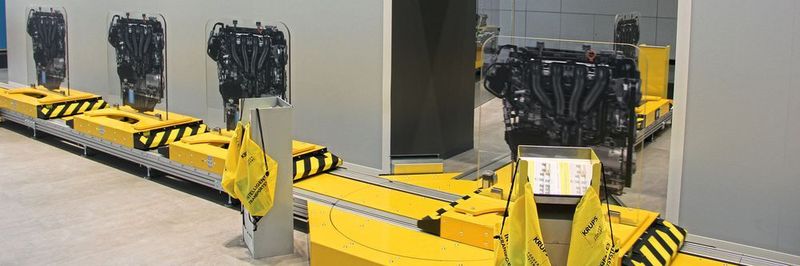 Beim Logomat-E-Cart- V2-System fährt ein elektrisches E-Cart mannlos auf einer Laufschiene. Drehmodule können die Laufrichtung ändern.
