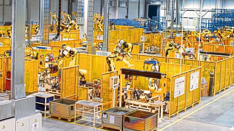Figure 1: A production line with robotic arms on a factory floor.