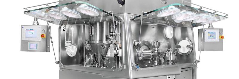 An isolator equipped for wet granulation in the mixer, fluidized bed drying, and wet and dry grinding.
