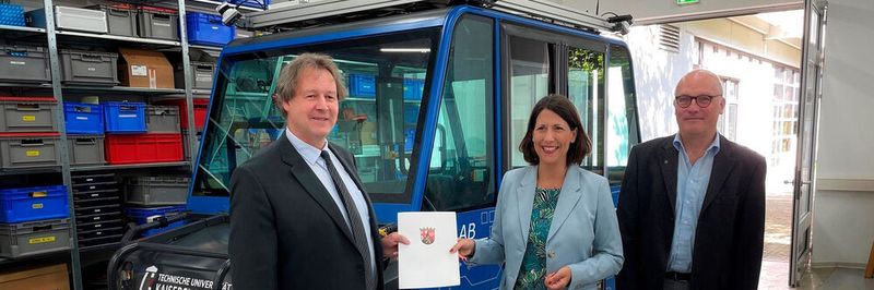 Im Zuge der Übergabe des Förderbescheids in Höhe von rund 780.000 Euro informierte sich Staatsministerin Daniela Schmitt auch über ein weiteres Projekt des Lehrstuhls Robotersysteme, ein autonomes Shuttle. Links: Prof. Dr. Karsten Berns, rechts: Prof. Dr. Werner Thiel.