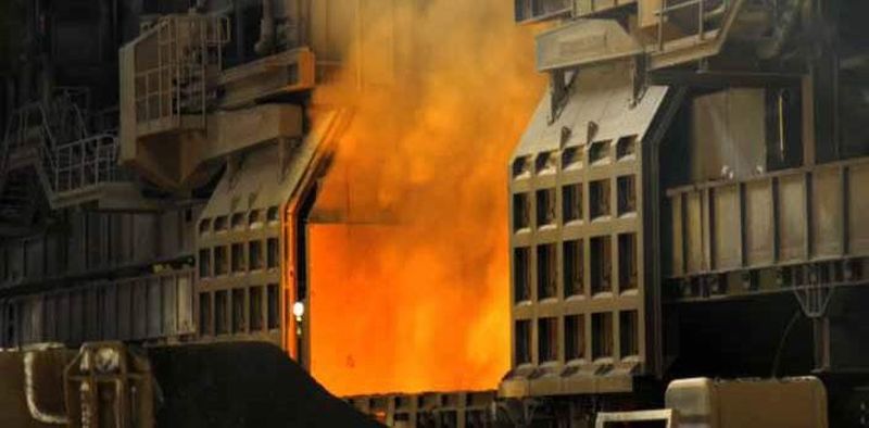 The iron ores are reduced in a blast furnace. The carbon-rich molten raw iron is converted into low-carbon steel in massive converter ladles
