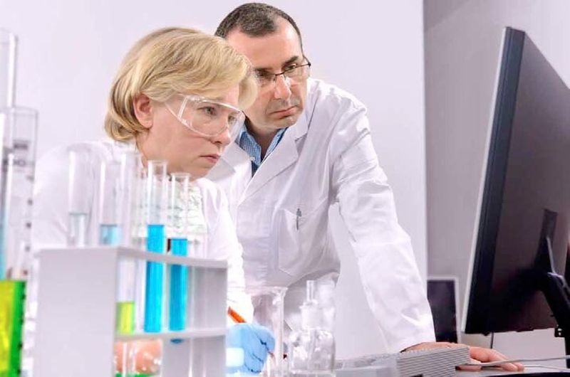 Personnel maintaining and documenting modifications that have been carried out since the previous shift cycle at a pharmaceutical factory